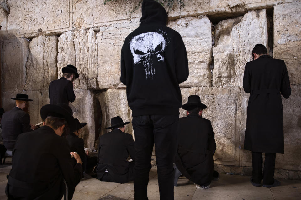 Ultra-Orthodox Jewish men pray during mourning ritual of Tisha B'Av (Ninth of Av) fasting and a memorial day, commemorating the destruction of ancient Jerusalem temples, at the Western Wall, the holiest site where Jews can pray in the Old City of Jerusalem, Sunday, July 18, 2021. (AP Photo/Oded Balilty)