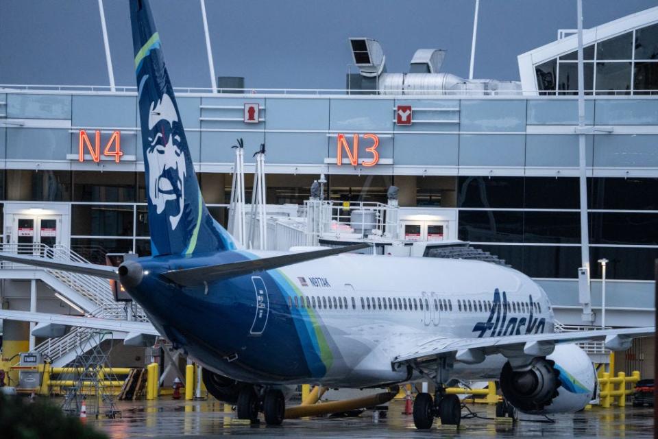 An Alaska Airlines Boeing 737 MAX 9 plane sits at a gate at Seattle-Tacoma International Airport. Alaska Airlines grounded its 737 MAX 9 planes after part of a fuselage blew off during a flight from Portland Oregon to Ontario, California.