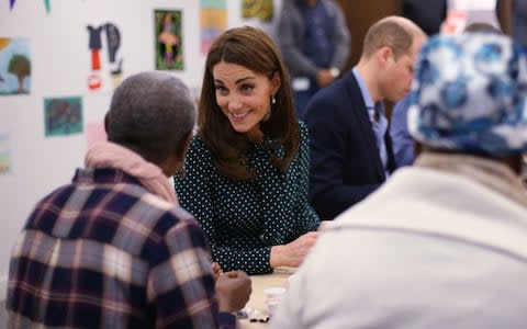 The Duke and Duchess of Cambridge speak to clients during an arts and crafts session at The Passage - Credit: Getty