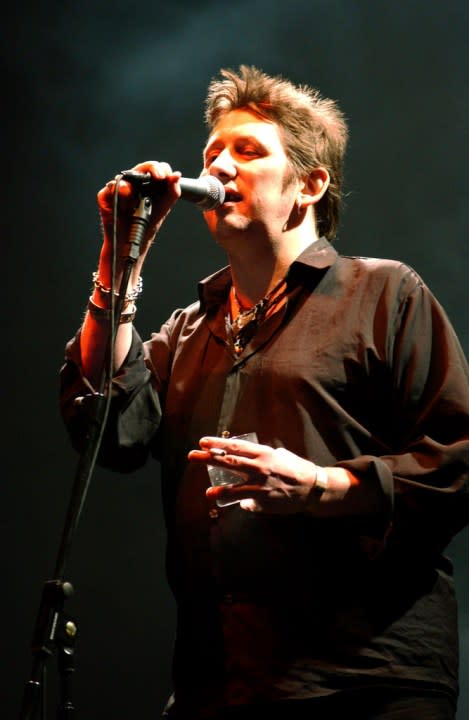 FILE – Shane McGowan performs live on stage at the Fleadh 2002 Music festival, Finsbury Park, North London, June 8, 2002. Macgowan, the singer-songwriter and frontman of The Pogues, best known for their ballad “Fairytale of New York,” has died. He was 65. His family said in a statement that “it is with the deepest sorrow and heaviest of hearts that we announce the passing of our most beautiful, darling and dearly beloved Shane Macgowan.” The singer died peacefully early Thursday, Nov. 30, 2023 with his family by his side, the statement added. (Andy Butterton/PA via AP, File)