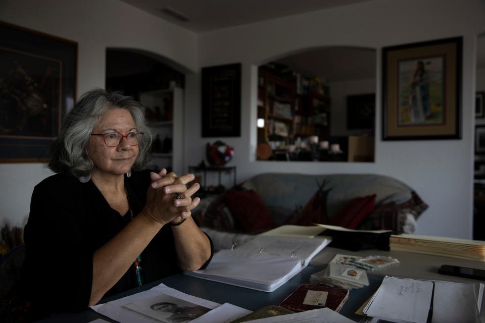 Dr. Robbie Paul looks over historical documents from Indian schools her relatives were at, in her home in Spokane, Wash. on Friday, Sept. 10, 2021.