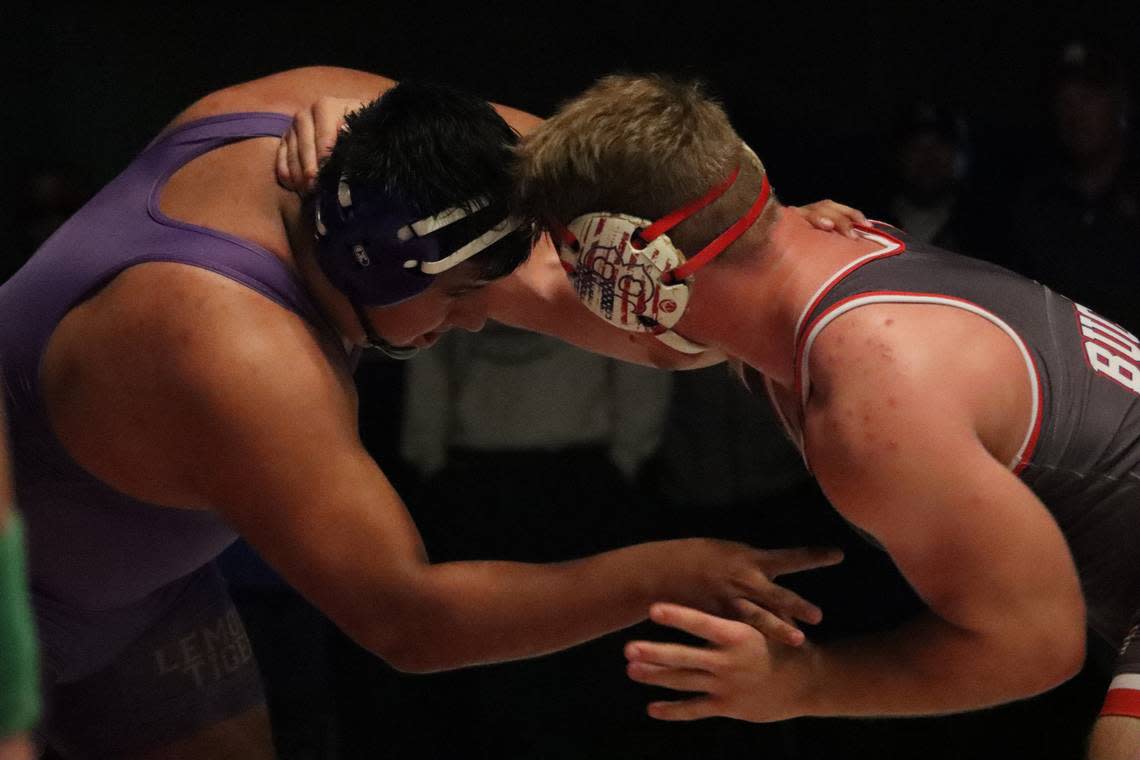 Lemoore High senior Isaiah Morales (left) scored a 3-2 decision in the 287-pound title match over Buchanan High’s Alec Dansby in the CIF Central Section Masters championships at Buchanan High on Feb. 18, 2023.