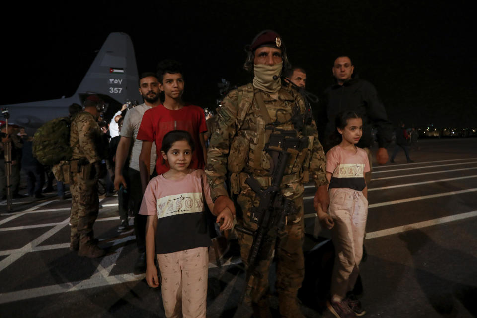 Jordanians evacuated from Sudan arrive at a military airport in Amman, Jordan, Monday, April 24, 2023. (AP Photo/Raad Adayleh)