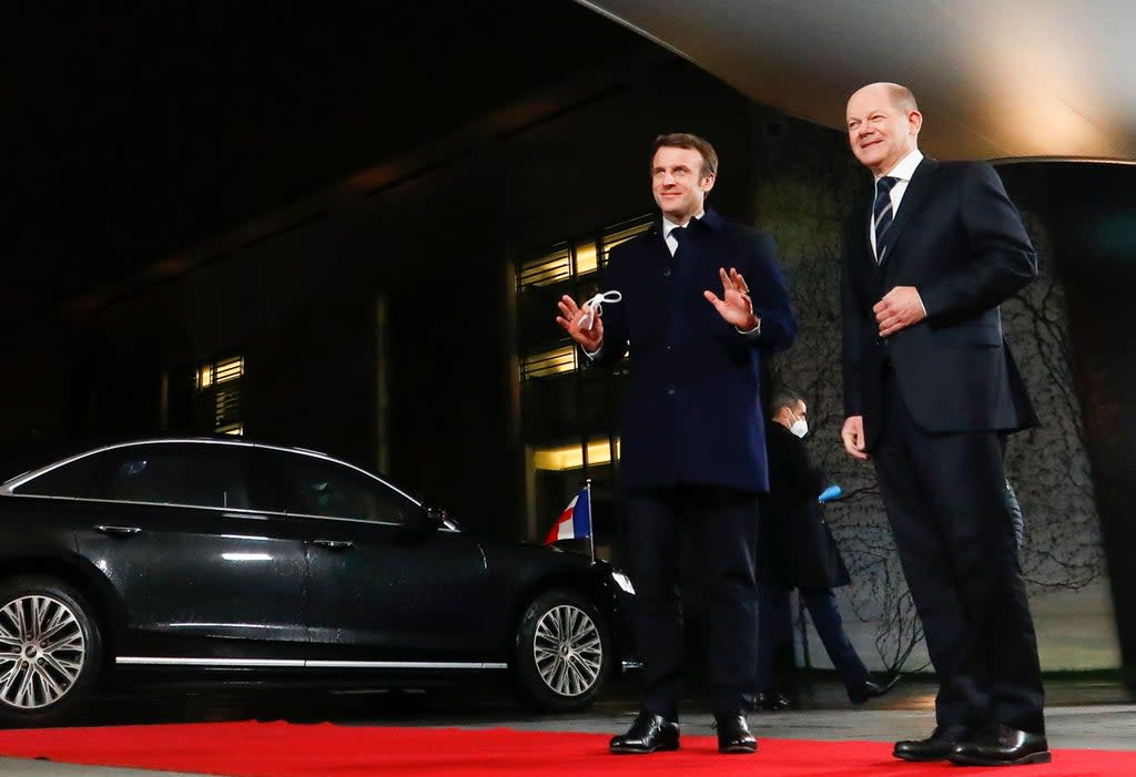 German chancellor Olaf Scholz (R) welcomes French president Emmanuel Macron (L) ahead of their meeting at the Federal Chancellery in Berlin, Germany (EPA)