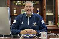 In this November 2020 photo, provided by Eugene "Geno" Thomas, Thomas, superintendent of the Lowellville, Ohio, School District, poses in his office. Contact tracing and isolation protocols meant to contain the spread of the coronavirus are sidelining school employees and frustrating efforts to continue in-person learning. “It boils down to the staff,” Thomas said. “If you can’t staff a school, you have to bring it to remote.” (Courtesy of Eugene Thomas via AP)