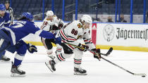 Chicago Blackhawks right wing Patrick Kane (88) breaks past Tampa Bay Lightning defenseman Ryan McDonagh (27) during the first period of an NHL hockey game Friday, Jan. 15, 2021, in Tampa, Fla. (AP Photo/Chris O'Meara)