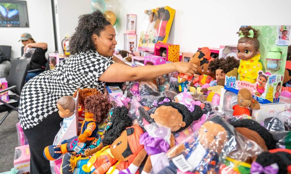 Brittany Viney of Better Life Children Services adds a doll to the collection during the National Council of Negro Women and Sacramento National Pan-Hellenic Council’s annual Black Baby Doll Drive in Arden Arcade on Thursday.