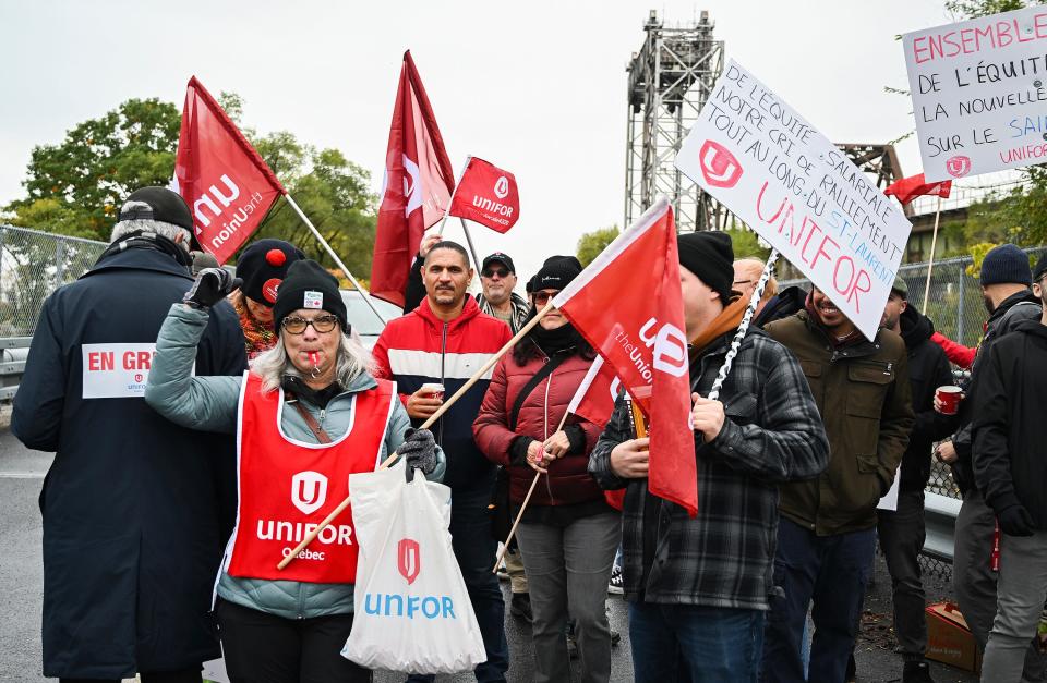 Striking St. Lawrence Seaway workers picket outside the St. Lambert Lock in St. Lambert, Quebec, Monday, Oct. 23, 2023. A strike has shut down all shipping on the St. Lawrence Seaway, interrupting exports of grain and other goods from Canada and the United States via the Great Lakes to the world.(Graham Hughes/The Canadian Press via AP)