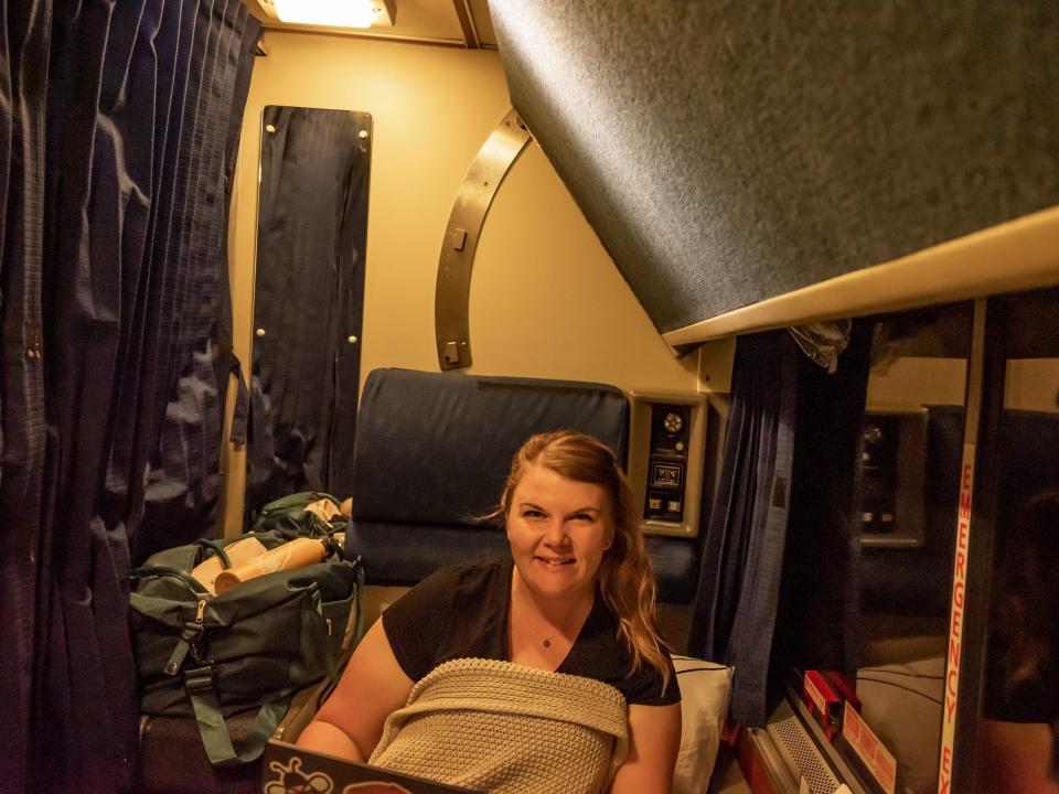 Molly Allen sitting in roomette on coast starlight amtrak train