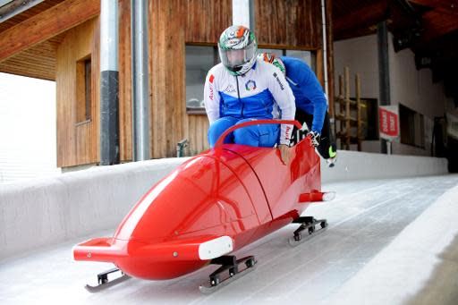 Italian bobsleigh team, Lukas Gschnitzer (front) and Giorgio Berdini train on October 15, 2013, in the French Alpine resort of La Plagne for the 2014 Winter Olympics games in Sochi