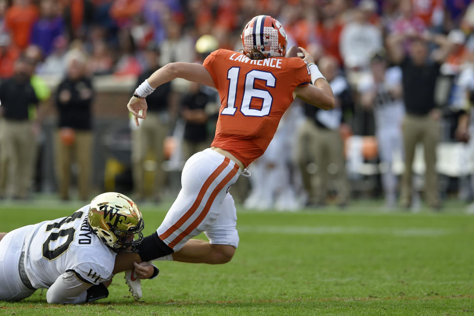 Clemson's Trevor Lawrence is sacked by Wake Forest's Rondell Bothroyd during the first half of an NCAA college football game Saturday, Nov. 16, 2019, in Clemson, S.C. (AP Photo/Richard Shiro)