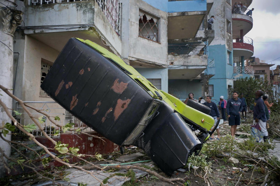 A truck is toppled against a home after a tornado in Havana, Cuba, Monday, Jan. 28, 2019. A tornado and pounding rains smashed into the eastern part of Cuba’s capital overnight, toppling trees, bending power poles and flinging shards of metal roofing through the air as the storm cut a path of destruction across eastern Havana. (AP Photo/Ramon Espinosa)