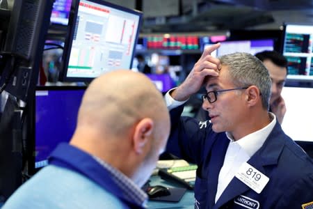 Traders work on the floor of the New York Stock Exchange shortly after the closing bell in New York