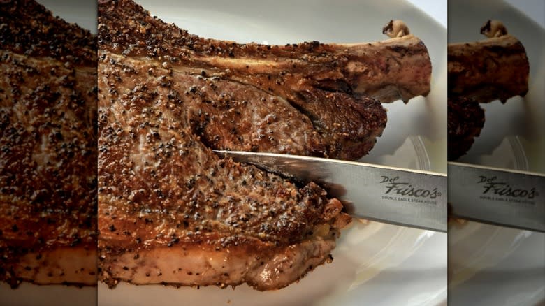 Close up of peppery steak with Del Frisco's knife