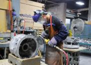 Workers at Mitchell Aerospace a manufacturer of light alloy sand castings for the aerospace industry