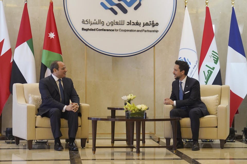 Jordan's Crown Prince Hussein and Egyptian President Abdel Fattah El-Sisi talk at the airport in Amman, Jordan, Tuesday, Dec. 20, 2022. Leaders from the Middle East and Europe gathered in Jordan Tuesday in a conference focused on bolstering security and stability in Iraq. (The Royal Hashemite Court via AP)