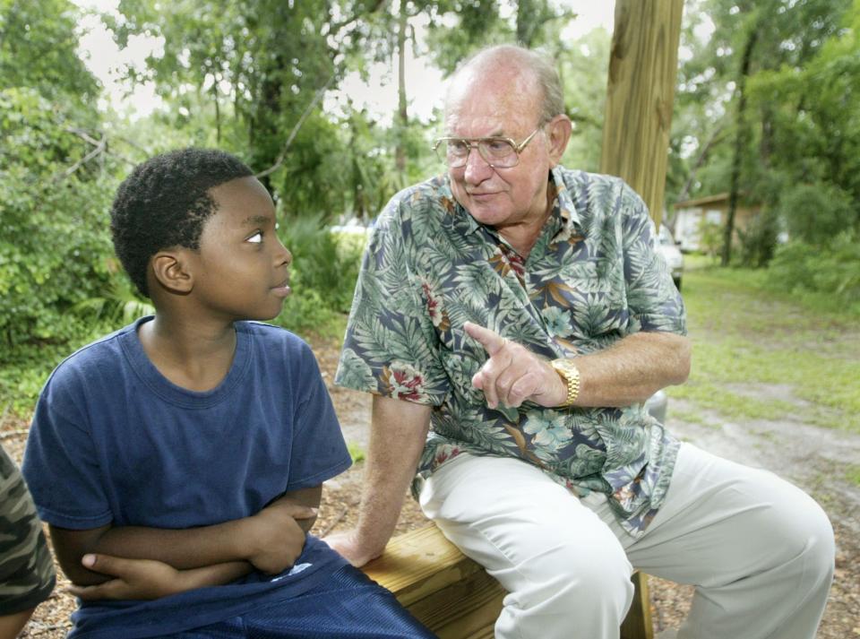 Jerry Joyce, 10, of Mulberry talks with Doc Dockery at Camp Wewa in Apopka on May 31, 2005. Over the years, Dockery sponsored hundreds of camp experiences for children who might have otherwise been unable to attend.