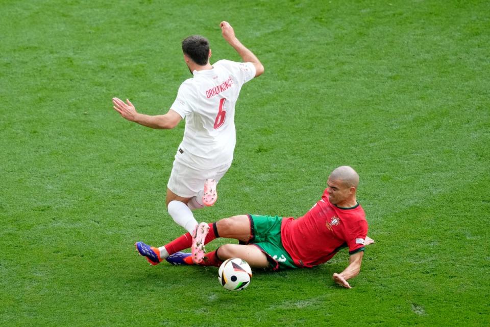 Pepe’s sliding tackle dispossesses Orkun Kokcu. (AP)