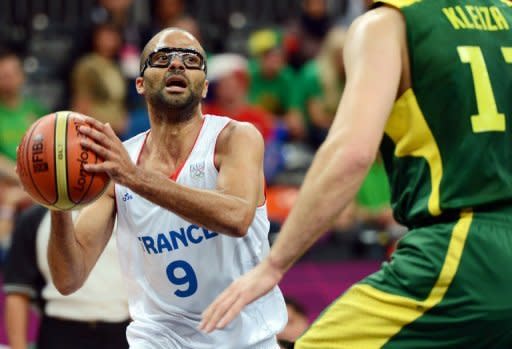 French guard Tony Parker (left) vies with Lithuanian forward Linas Kleiza during the men's preliminary round basketball match of the London 2012 Olympic Games at the basketball arena in London. Parker scored 27 points and France took a big step toward reaching the medal playoffs in the Olympic men's basketball tournament by defeating Lithuania 82-74