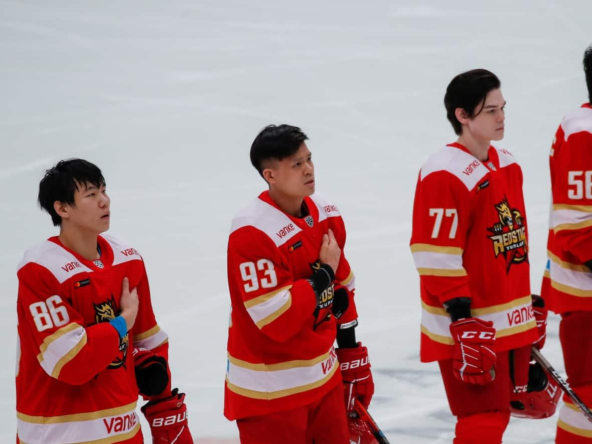 China's HC Kunlun Red Star players listen to China's national anthem before the Kontinental Hockey League (KHL) match against HC Amur Khabarovsk in Mytishchi, Moscow region, Russia, on Nov. 15. (REUTERS/Maxim Shemetov - image credit)