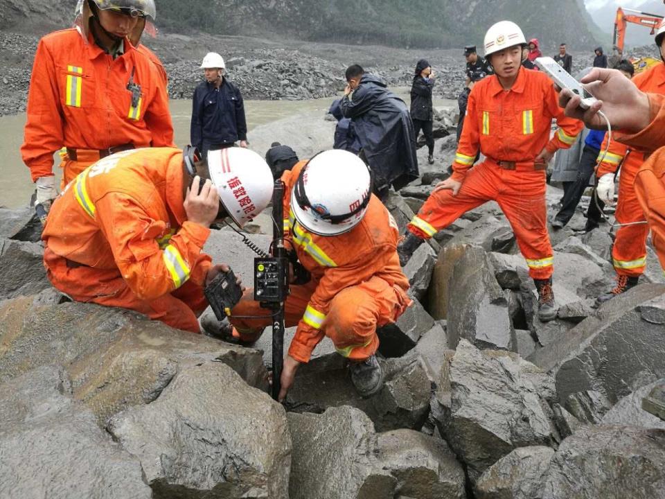 Rescuers work at the landslide site