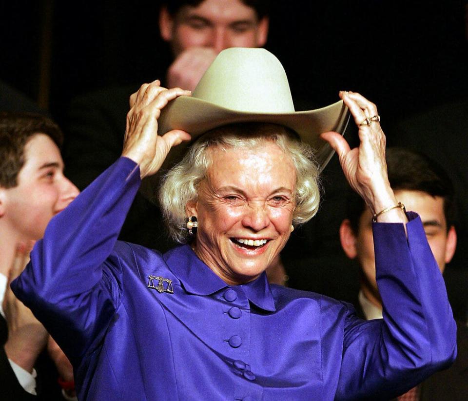 Supreme Court Justice Sandra Day O'Connor dons a cowboy hat, given to her during an event at the University of Houston Law Center on March 10, 2005, in Houston.