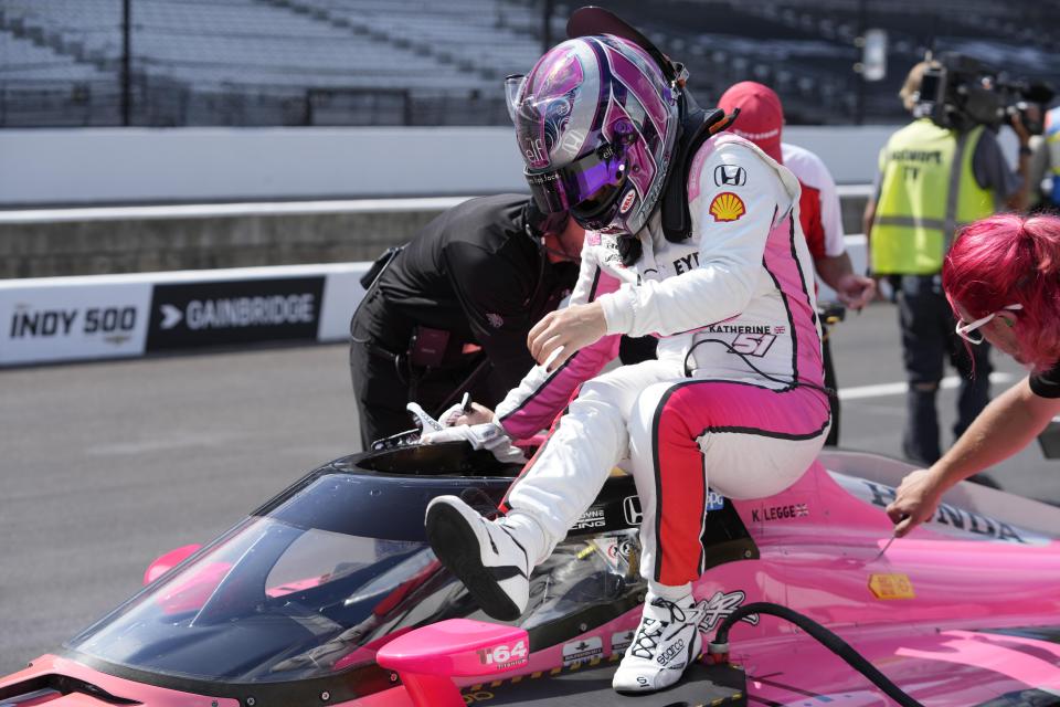 Katherine Legge, of England, climbs out of her car during qualifications for the Indianapolis 500 auto race at Indianapolis Motor Speedway, Sunday, May 19, 2024, in Indianapolis. (AP Photo/Darron Cummings)