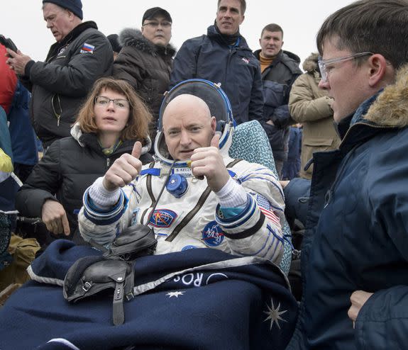 Scott Kelly of NASA rest in a chair outside of the Soyuz spacecraft.