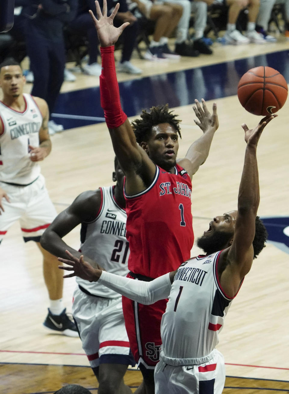 UConn guard R.J. Cole shoots as St. John's forward Josh Roberts (1) defends, in the first half of an NCAA college basketball game in Storrs, Connecticut, Monday, Jan. 18, 2021. (David Butler II/Pool photo via AP)