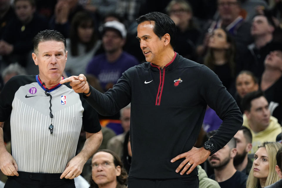 Miami Heat head coach Erik Spoelstra, right, argues with referee Pat Fraher, left, during the first half of an NBA basketball game against the Phoenix Suns in Phoenix, Friday, Jan. 6, 2023. (AP Photo/Ross D. Franklin)