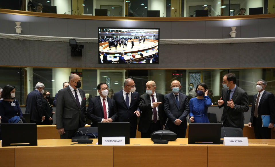 From second left, Spain's Foreign Minister Jose Manuel Albares Bueno, Croatia's Foreign Minister Gordan Grlic Radman, French Foreign Minister Jean-Yves Le Drian, Portugal's Foreign Minister Augusto Santos Silva German Foreign Minister Annalena Baerbock and Slovenia's Foreign Minister Anze Logar during a meeting of EU foreign ministers at the European Council building in Brussels on Monday, Dec. 13, 2021. European Union foreign ministers met Monday to discuss how to thwart the threat of a possible new Russian invasion of Ukraine and what measures to take should Moscow decide to send its troops across the border. (AP Photo/Virginia Mayo)