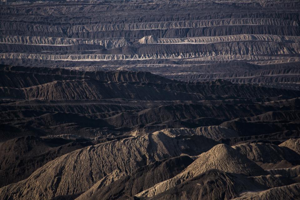 FILE - Mining debris covers the ground of a lignite coal pit near the village of Welzow in the Lusatia (Lausitz) area in Germany, June 5, 2018. Germany is shutting down its last three nuclear power plants on Saturday, April 15, 2023, as part of an energy transition agreed by successive governments. Critics have warned that without nuclear power, Germany will have to rely on dirty coal and gas plants for energy during periods of overcast but calm weather. (AP Photo/Markus Schreiber, File)