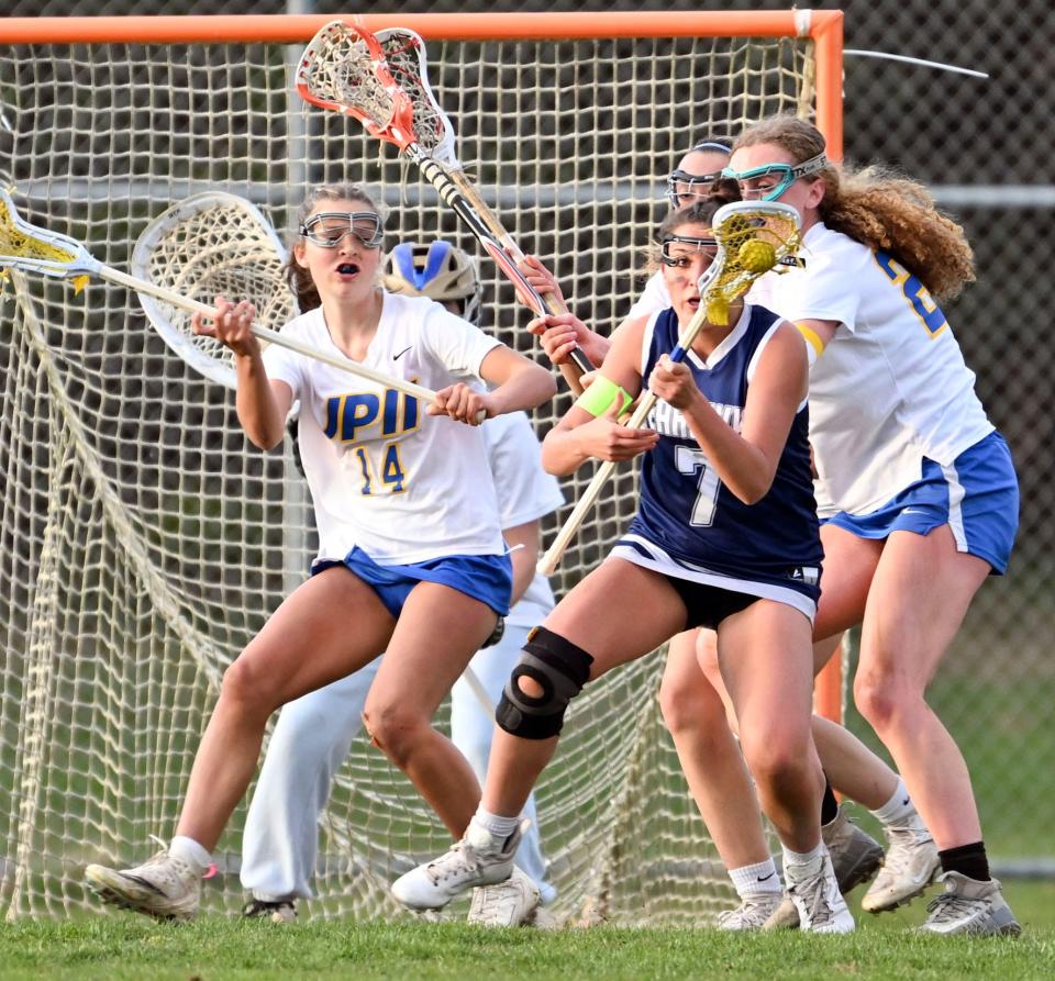 SANDWICH  4/24/23     Ella Bartolomei of Cape Cod Academy turns on Meah Dalrymple (14) and Maggie Crofford of St. John Paul II.