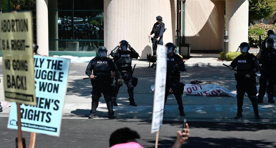 Sheriff’s deputies and Modesto Police engage protestors try and clear the area around the Planned Parenthood office on McHenry Ave during an opposition rally that began as a protest to the Straight Pride event in Modesto, Calif., on Saturday, August 27, 2022.