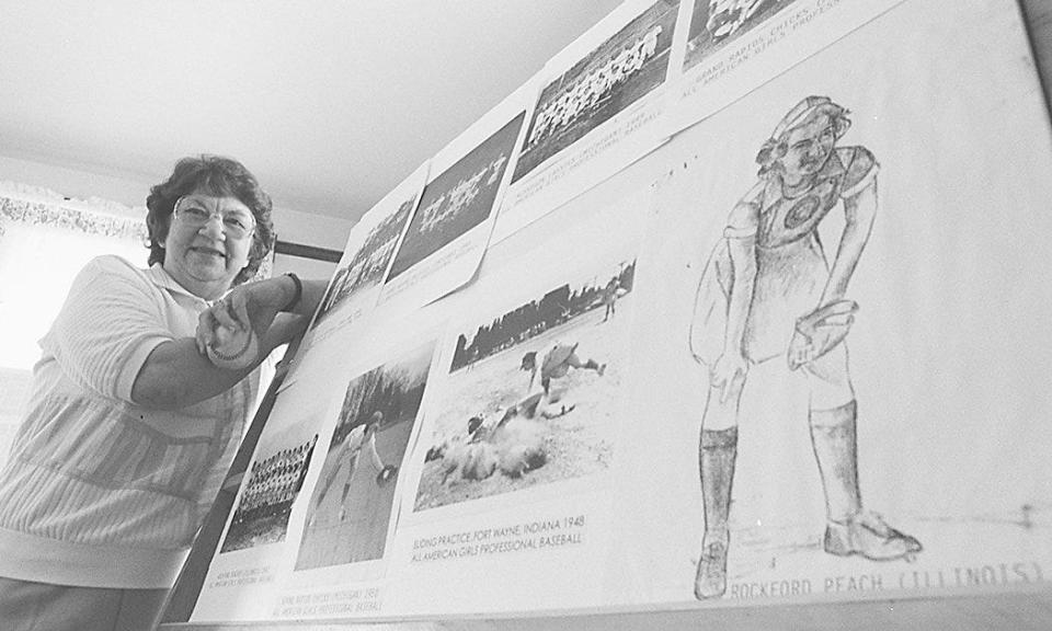 Marie Wegman, a former women's league baseball player, with a display of photos and drawings of herself and her teams on display at the Delhi Historical Society.