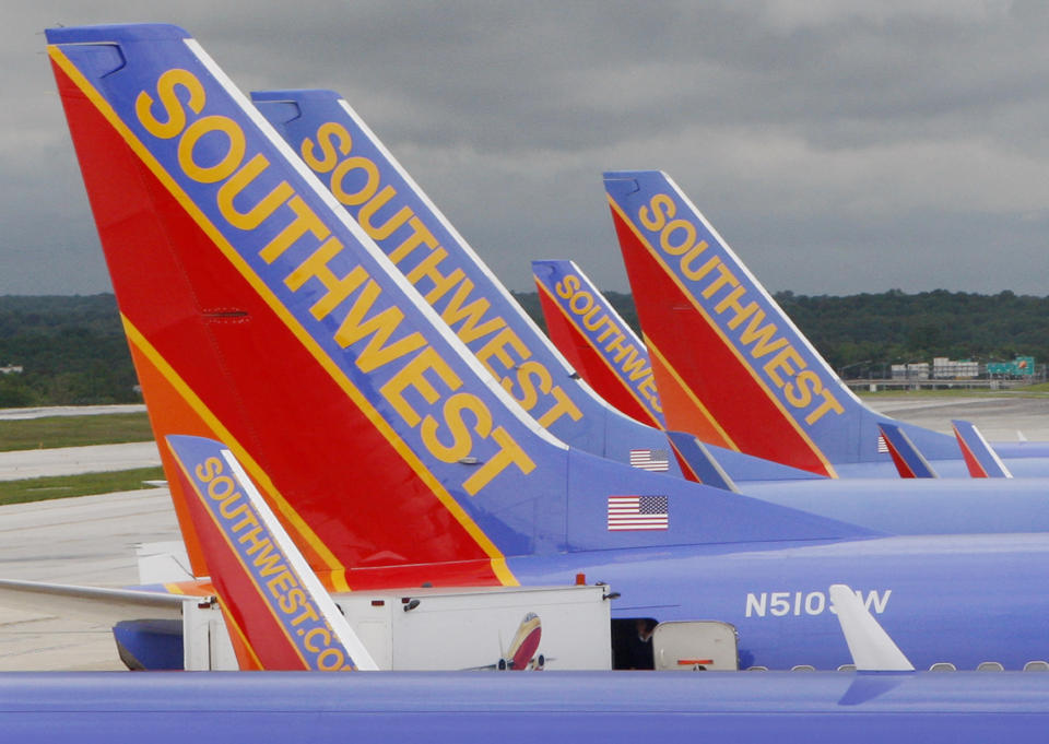 FILE - In this May 16, 2008 file photo, Southwest Airlines jets are seen parked at their gates at Baltimore Washington International Airport in Baltimore, Md. Southwest Airlines will reduce flights for the rest of the year as it tries to restore an operation that stumbled over the summer and now faces lower demand because of the rise in coronavirus cases. Southwest said Thursday, AUg. 26, 2021 it will cut its September schedule by 27 flights a day, or less than 1%, and chop 162 flights a day, or 4.5% of the schedule, from early October through Nov. 5. (AP Photo/Charles Dharapak, file)