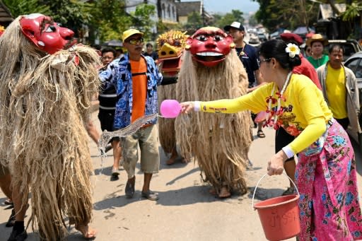 Revellers traditionally splash water on the legendary ancestors "Pou Nyer" and "Nyar Nyer" during their annual procession Luang Prabang
