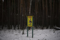 A sign reads "don't be a poacher, hunt by the rules" close to the border with Belarus, Ukraine, Wednesday, Feb. 1, 2023. Reconnaissance drones fly several times a day from Ukrainian positions across the border into Belarus, a close Russian ally, scouring for signs of trouble on the other side. Ukrainian units are monitoring the 1,000-kilometer (650-mile) frontier of marsh and woodland for a possible surprise offensive from the north, a repeat of the unsuccessful Russian thrust towards Kyiv at the start of the war nearly a year ago. (AP Photo/Daniel Cole)
