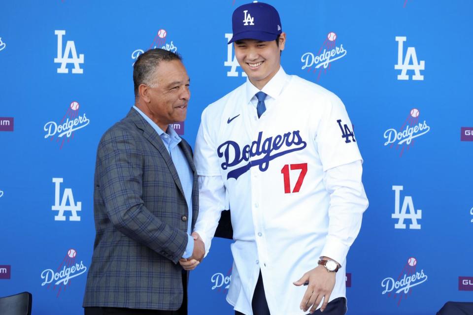 Dave Roberts and Shohei Ohtani shake hands.