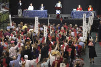 Delegates raise red cards to object to a proposal being debated at the South Carolina Republican Party State Convention at River Bluff High School on Saturday, May 20, 2023, in Lexington, S.C. (AP Photo/Meg Kinnard)