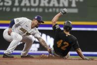 Milwaukee Brewers' Jace Peterson tags out Pittsburgh Pirates' Adam Frazier as he is caught stealing second during the third inning of a baseball game Friday, April 16, 2021, in Milwaukee. (AP Photo/Morry Gash)