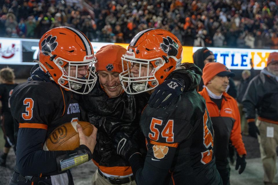 Byron coach Jeff Boyer hugs his player after winning the Class 3A state championship game on Friday, November 26, 2021 in DeKalb.