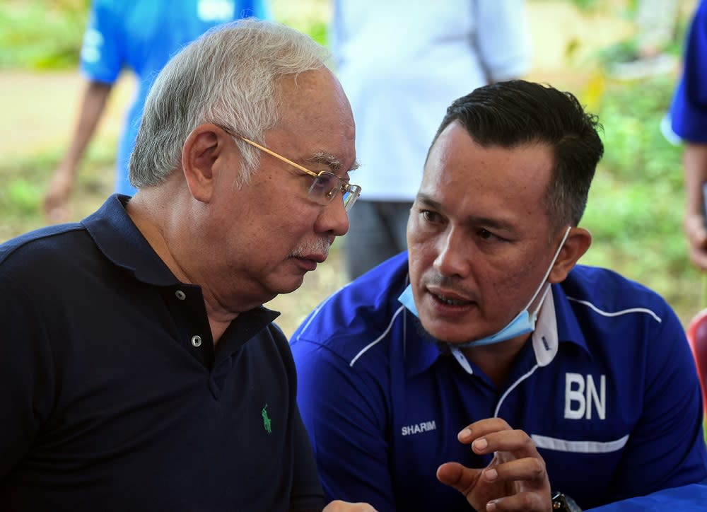 Datuk Seri Najib Razak (left) and Barisan Nasional’s candidate for the Chini by-election Mohd Sharim Md Zain are seen chatting during a visit to the Jakun Orang Asli settlement near Pekan June 25, 2020. — Bernama pic