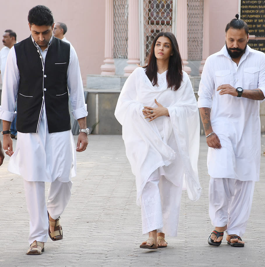 Abhishek Bachchan accompanies Aishwarya.