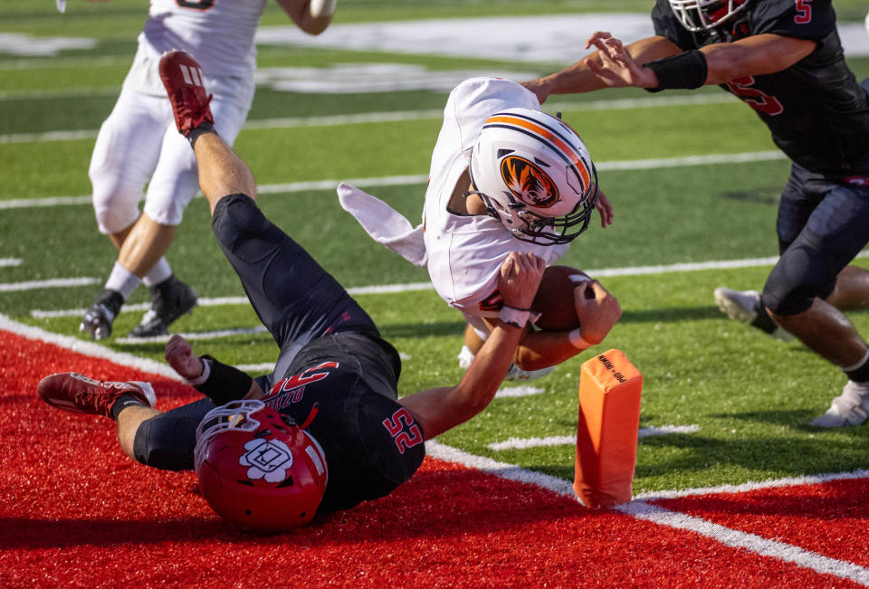 Republic QB Wyatt Woods reaches the pylons through the tackle of Ozark’s Charles Lawson on Thursday, August 31, 2023.
