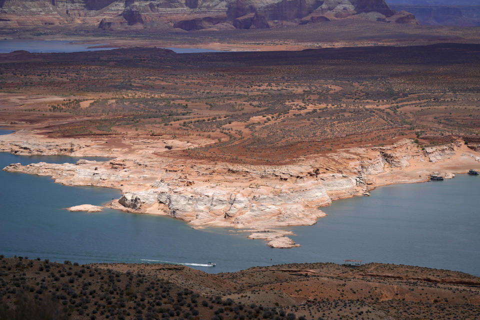 A boat moves along Wahweap Bay along the Upper Colorado River Basin, Wednesday, June 9, 2021, at the Utah and Arizona border near Wahweap, Ariz. Included in the infrastructure deal that became law last month is $2.5 billion for Native American water rights settlements, which quantify individual tribes’ claims to water and identify infrastructure projects to help deliver it to residents. On the Navajo Nation, the largest reservation in the U.S., the money could fund a settlement reached in 2020 over water in the upper Colorado River basin. (AP Photo/Ross D. Franklin)