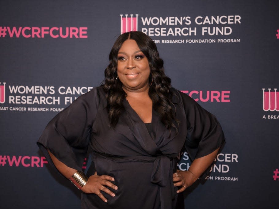 Loni Love wearing a black dress