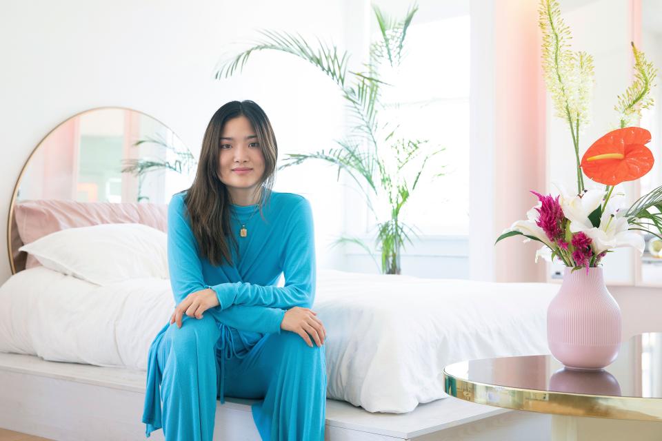 Hannah Park at home, wearing a knit set from OORI OTT, her Los Angeles-based clothing label.