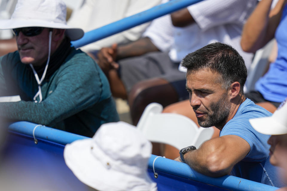 CORRECTS THAT SAKKARI IS FROM GREECE, NOT GERMANY - Coach Pere Riba, right, watches Coco Gauff, of the U.S., against Maria Sakkari, of Greece, during the women's singles final of the DC Open tennis tournament Sunday, Aug. 6, 2023, in Washington. (AP Photo/Alex Brandon)