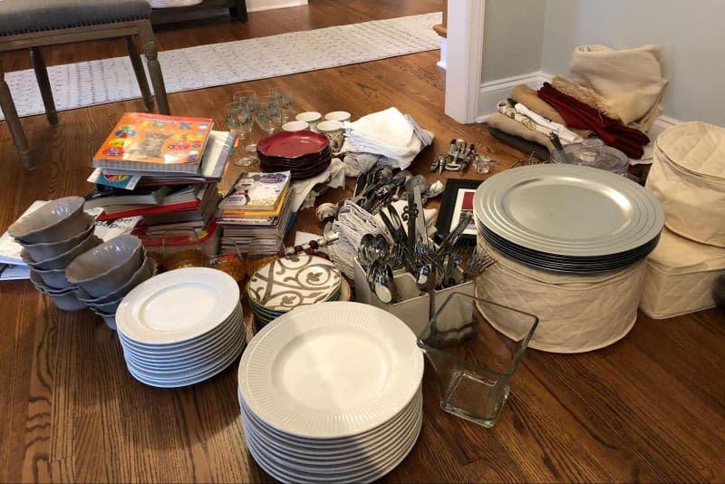 Dinnerware stacked on dining table.